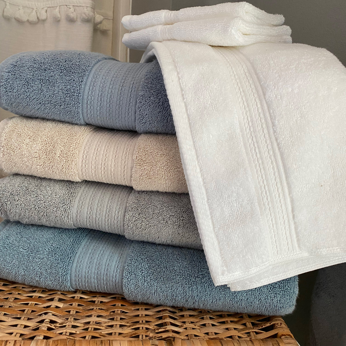 Multiple colors of American Choice towels stacked and folded